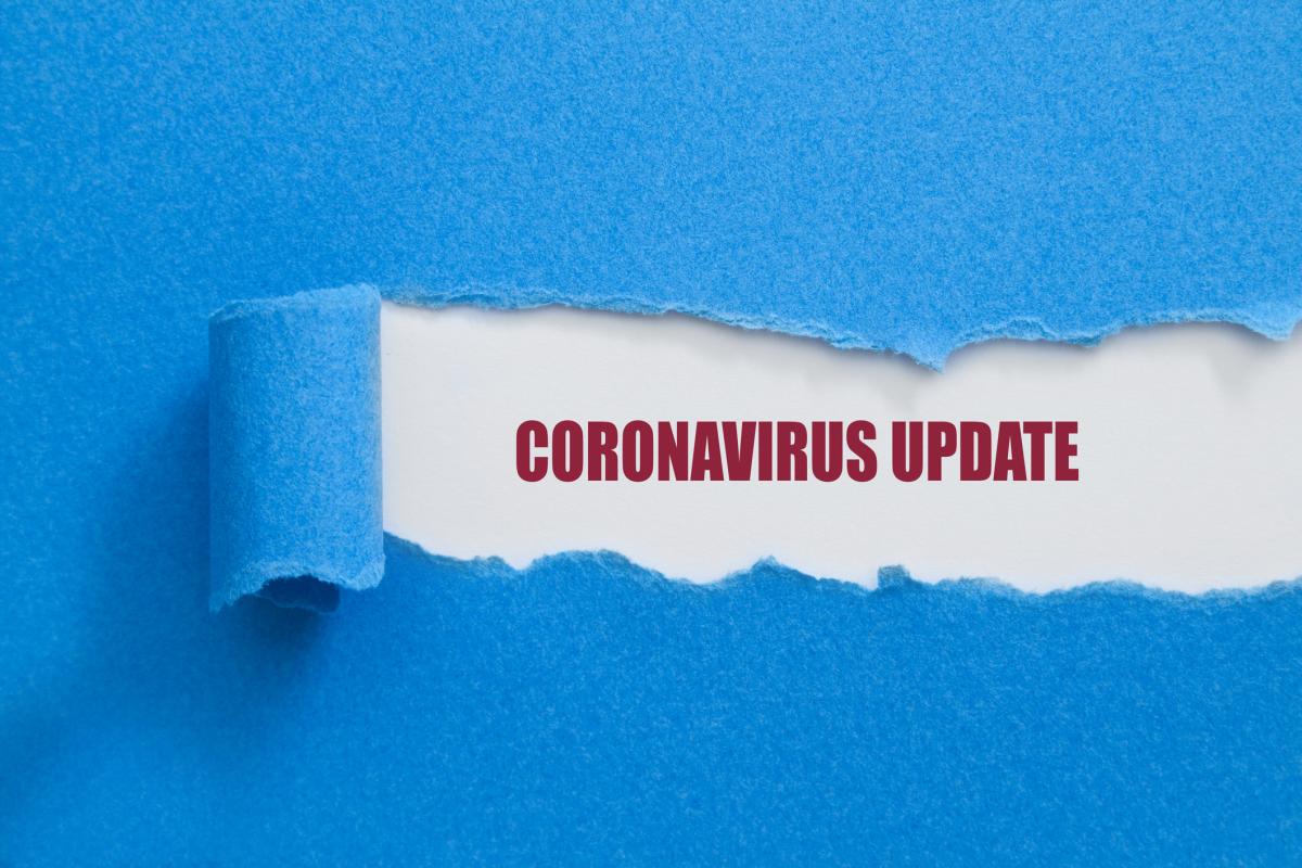Blue paper being peeled back to reveal the words Coronavirus Updates