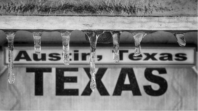 Icicles hanging in front of an Austin, Texas, sign