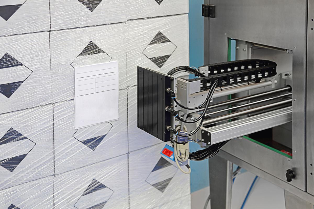 Close up shot of the tamping mechanism on an industrial labeling machine